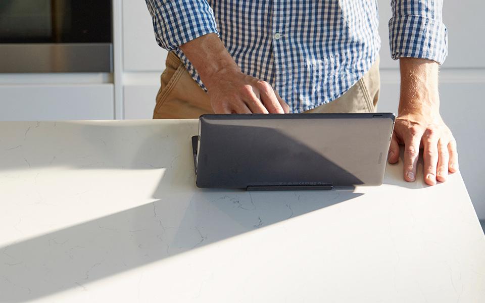 Person typing on laptop computer with sun casting bright light on hands